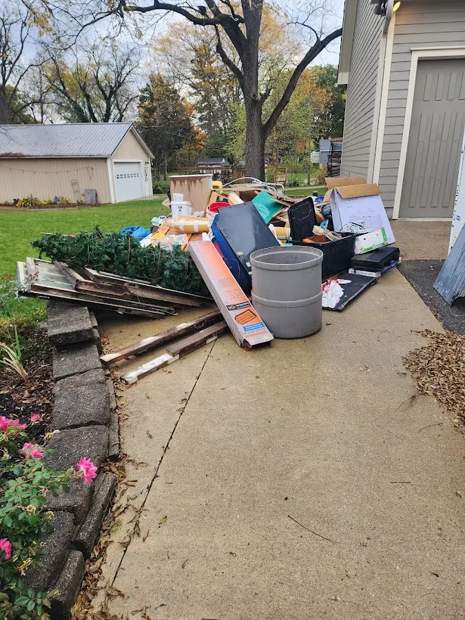 Dumpster being loaded with debris for 12 Yard Dumpster Rental in Palacios